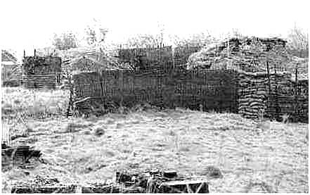 Bunker positions at the bottom of the tower with pallets of building supplies in the 
foreground.